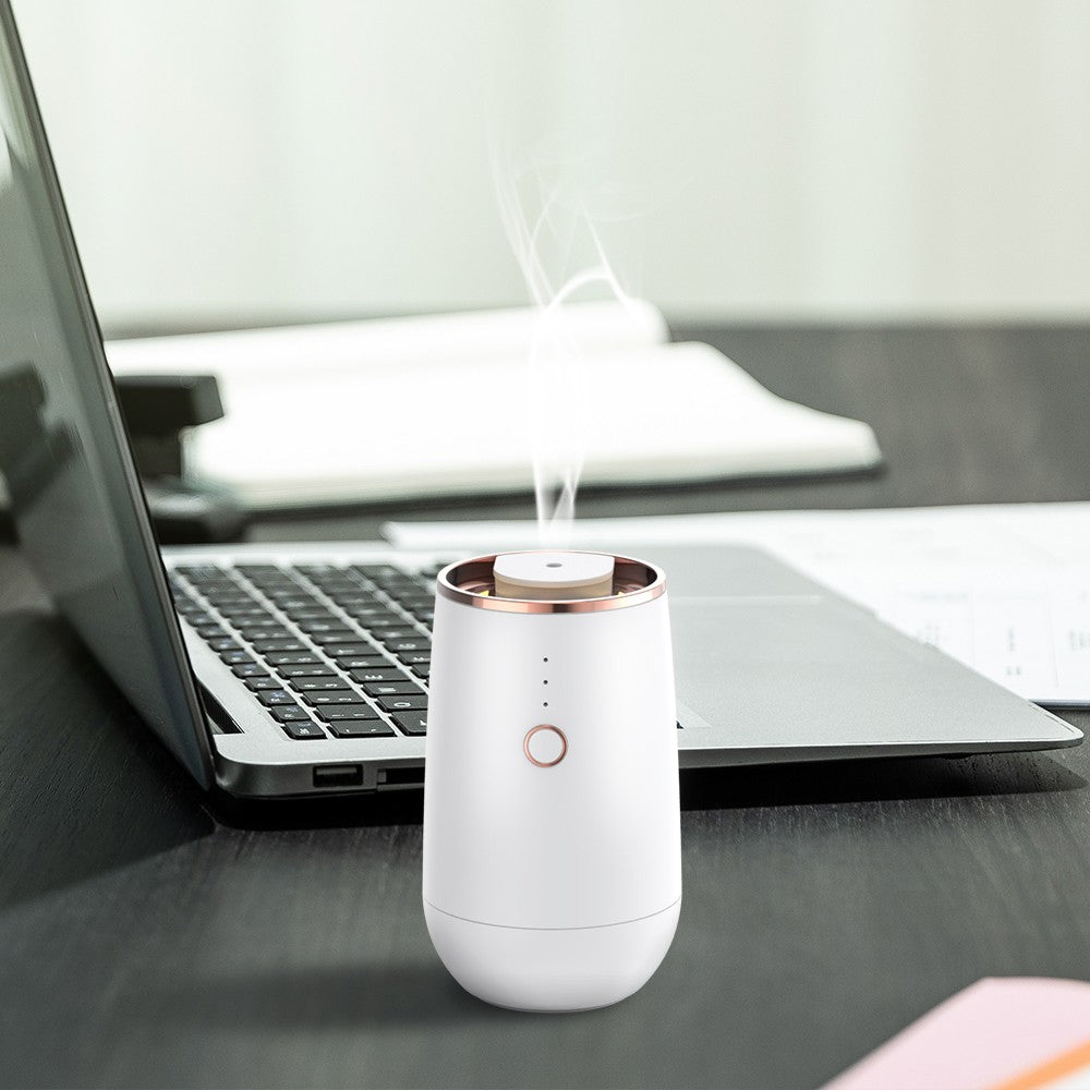 WSNUEEE A603 cordless diffuser standing on a desk at the office, scent drifting up from the nozzle
