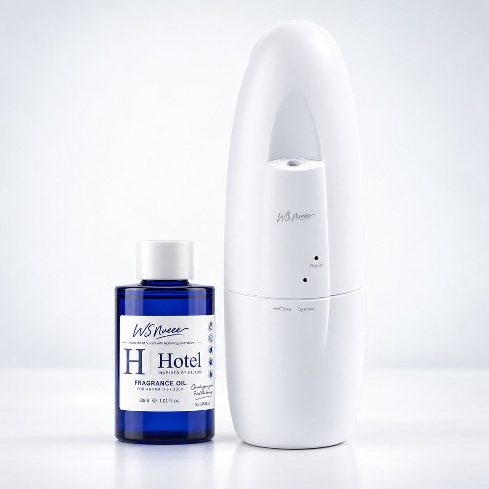 WSNUEEE waterless aroma diffuser beside a 30 mL bottle of H Hotel fragrance oil